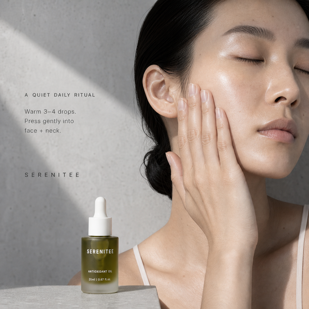 Woman gently pressing Serenitee Blue Tansy Antioxidant Face Oil into her cheek as part of a daily skincare ritual.